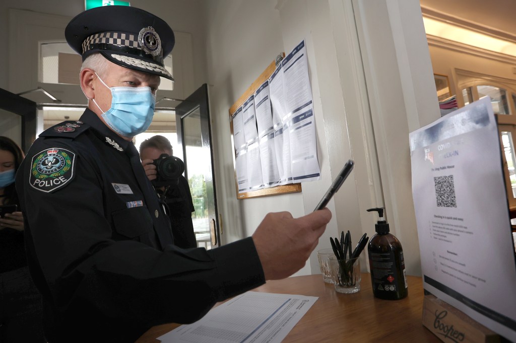 Police Commissioner Grant Stevens checks in with an Adelaide hotel's QR system. Photo: Tony Lewis/InDaily