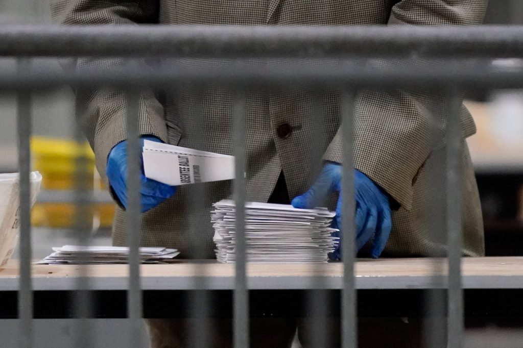 An official counts ballots for Georgia's Senate runoff election at the Georgia World Congress Center. Photo: Brynn Anderson / AP