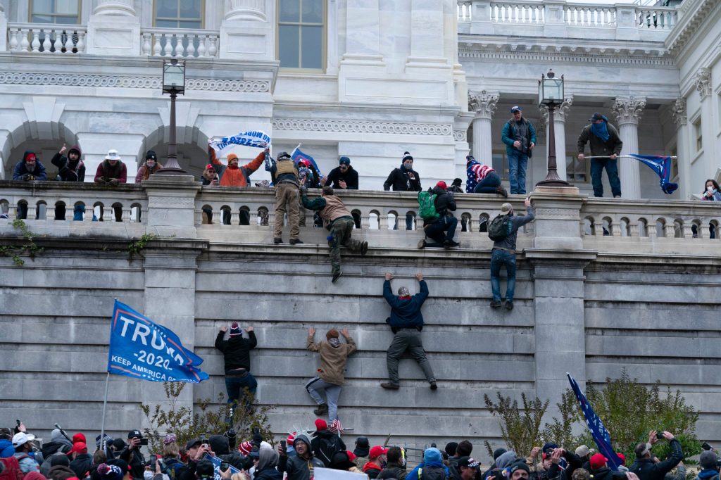 Trump supporters climb into the US Capitol following claims the election result was fraudulent. Photo: AP/Jose Luis Magana