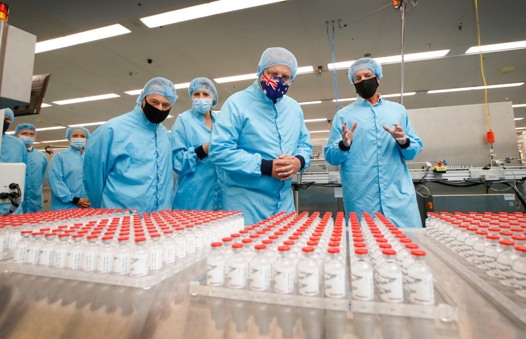 Prime Minister Scott Morrison with the  AstraZeneca vaccine. Photo: David Caird/AAP 