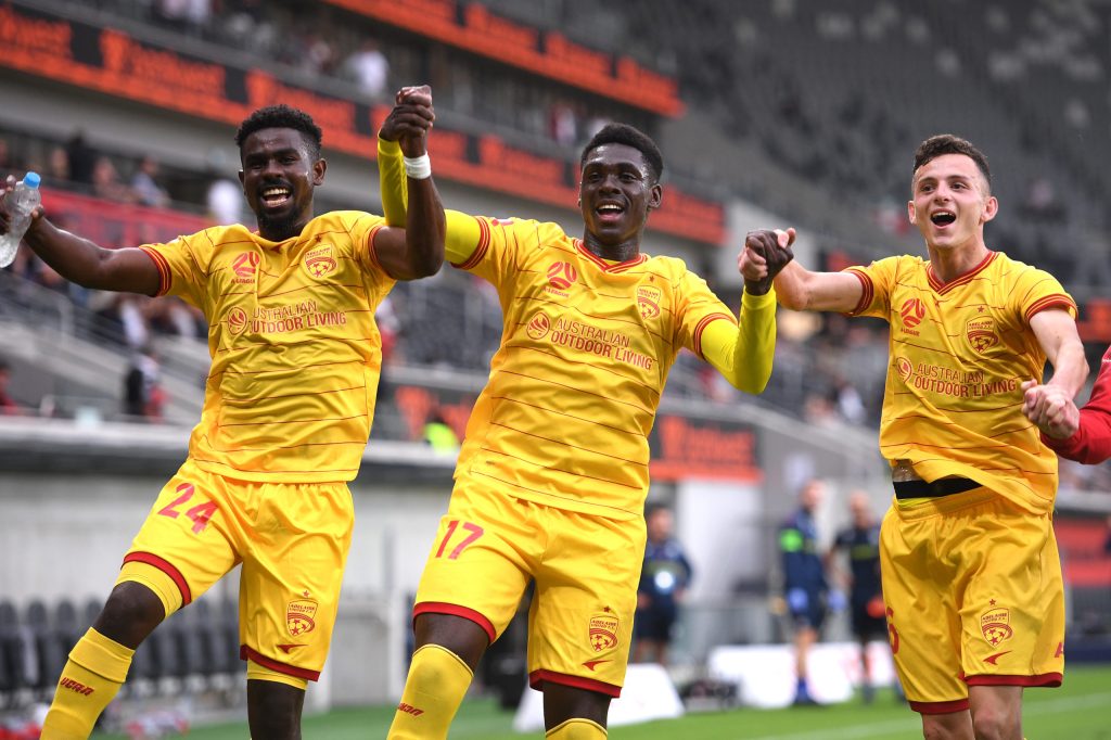 United's Pacifique Niyongabire, Mohamed Toure and Louis D’Arrigo celebrate last Saturday's win over Western Sydney. Photo: AAP/Dan Himbrechts