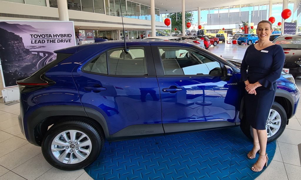 CMI Toyota Adelaide new car sales consultant Danielle Andersen with one of the hybrid models, which is helping to drive a sales surge. Picture: Andrew Spence.