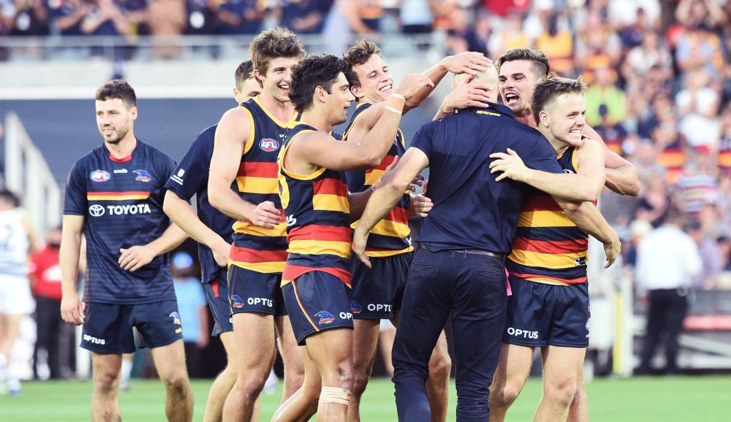 Crows players get around coach Matthew Nicks after the final siren. Photo: Michael Errey / InDaily