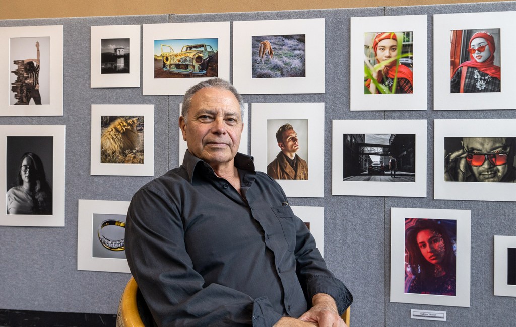 Photography teacher Malcolm Cheffirs with an exhibition of his students' work
Photo: Tony Lewis / InDaily