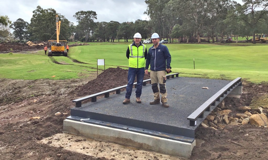 SIS structures director Nick Wotton and Castle Hill Country Club superintendent Mitch Brooks on one of the newly installed FRP bridges in July 2019.