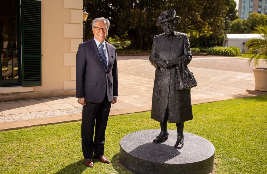 Governor Hieu Van Le poses next to the new statue of the Queen unveiled at Government House (Photo: Tony Lewis/InDaily)