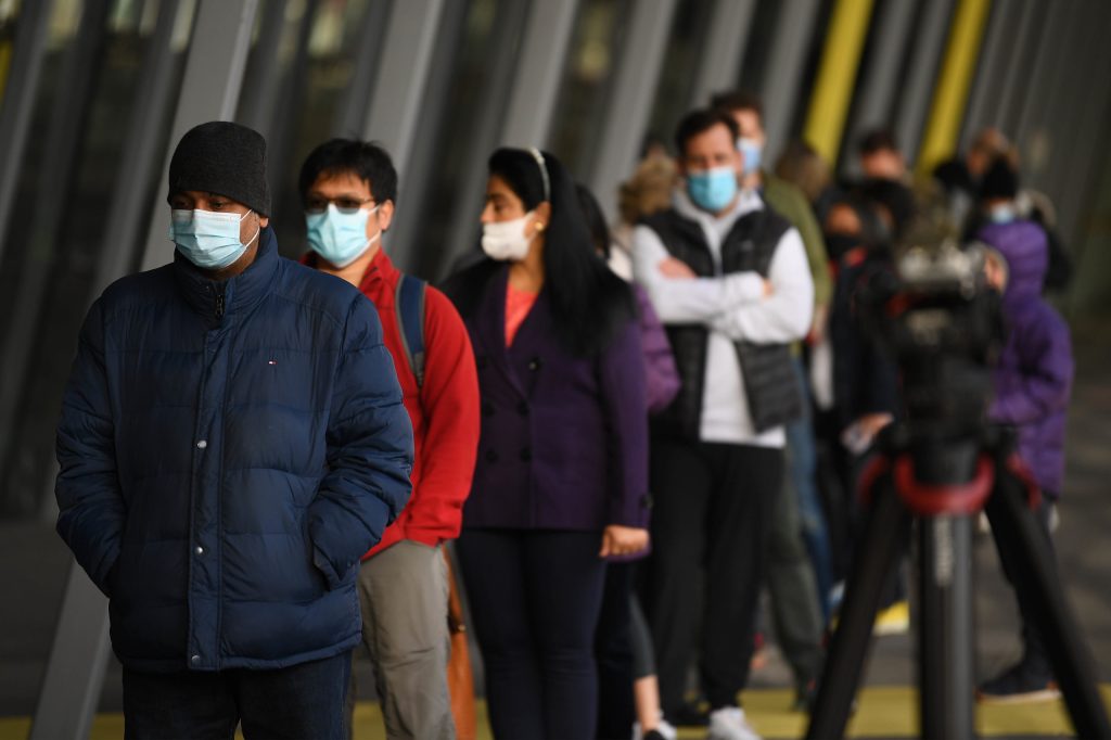 People queue to be vaccinated in Melbourne in June. Photo: AP/James Ross