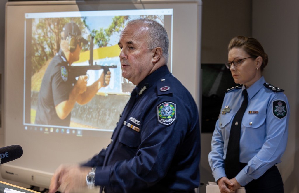 SA Police assistant commander Peter Harvey and AFL commander Erica Mirren with images of an automatic weapon seized during raids. (Photo: Tony Lewis/InDaily)