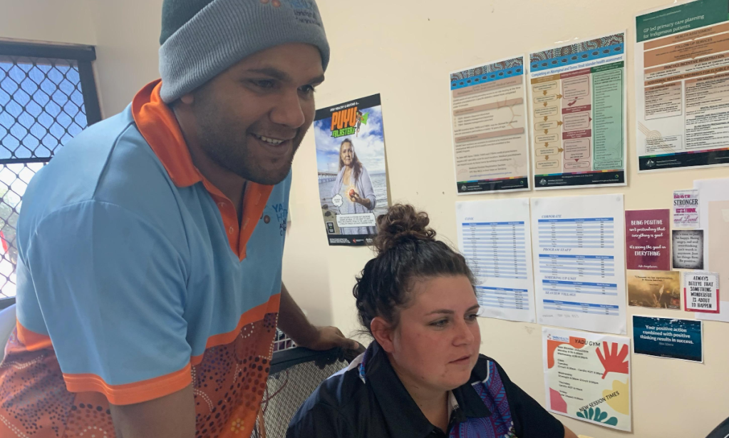 Jerome Newchurch from Ceduna supporting Yadu Aboriginal Corporation staff member with IT issue after undergoing training with New Future IT.