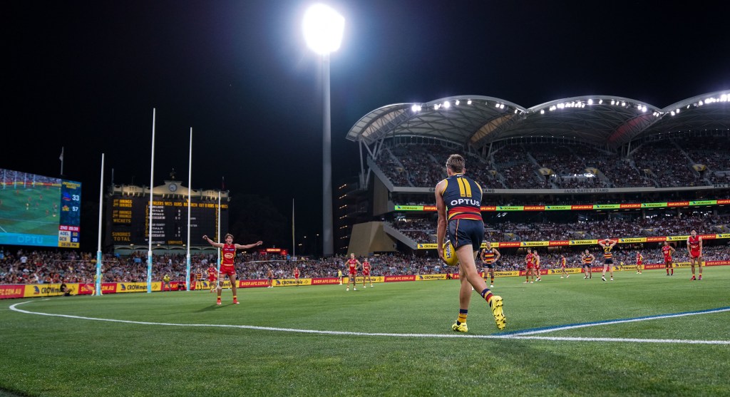 Adelaide's Paul Seedsman kicks for goal. Photo: AAP/Matt Turner