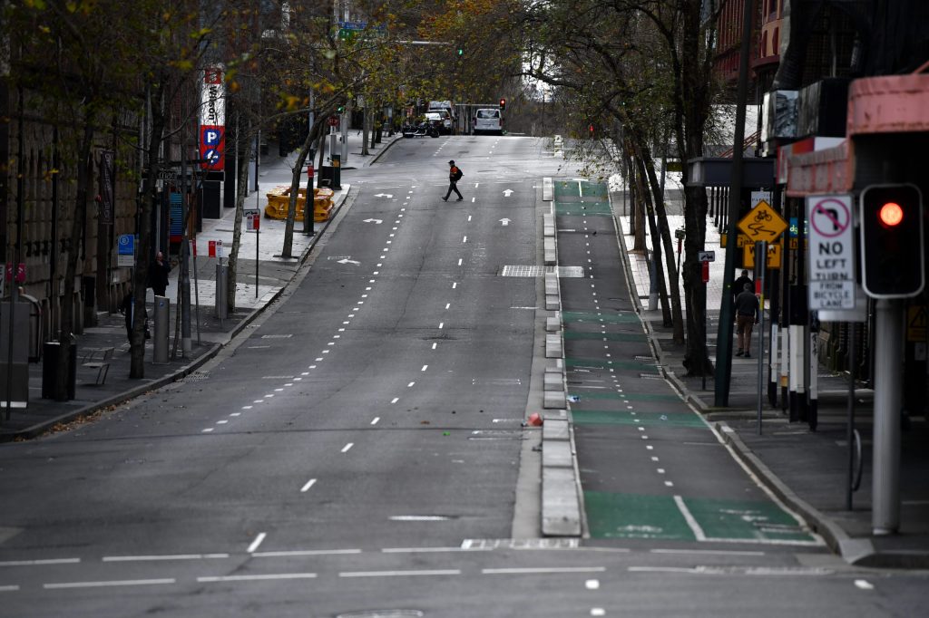 A pedestrian wearing a face mask in the central business district in Sydney Sydney (AAP Image/Joel Carrett)