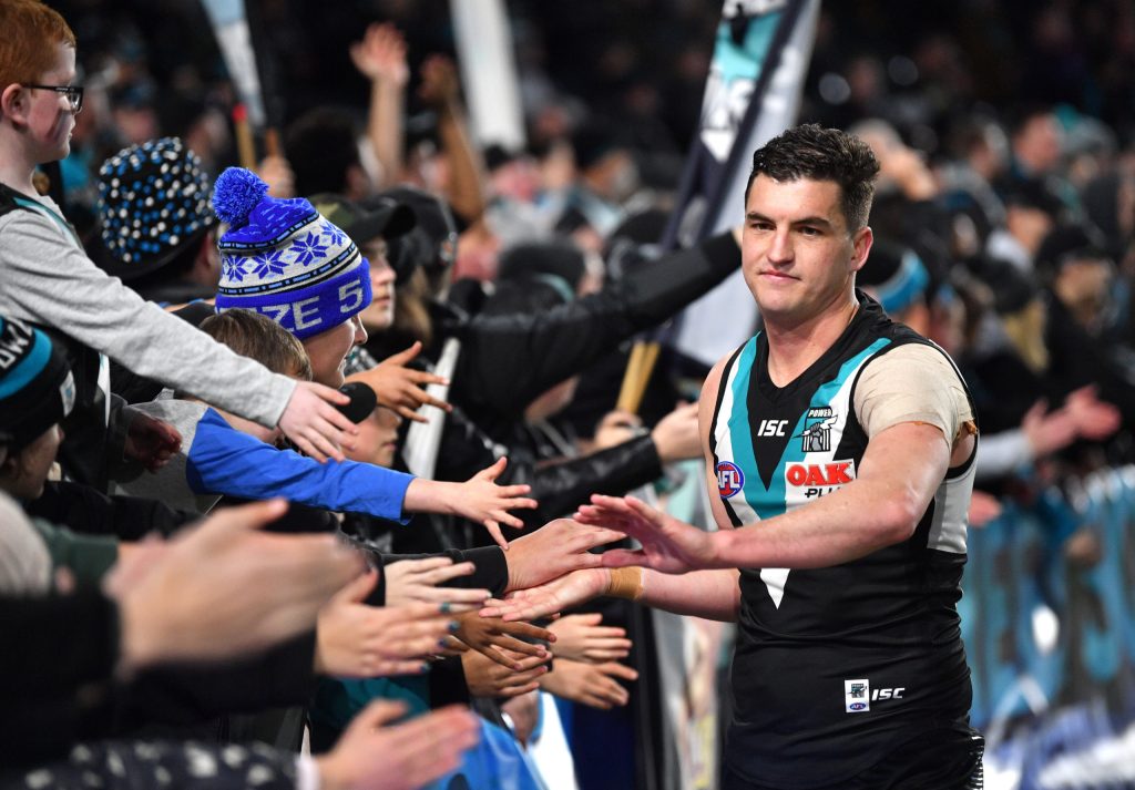 Tom Rockliff of the Power celebrates with fans after a game in 2019 (AAP Image/David Mariuz)