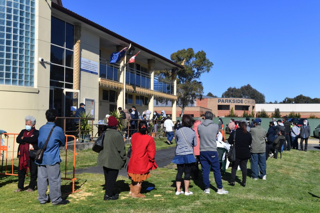 Members of the public queue at a mobile AstraZeneca vaccination clinic at the Community Hall of the Lao Cultural Centre in the south western suburb of Edensor Park in Sydney, Wednesday, August 4, 2021 (AAP Image/Mick Tsikas)