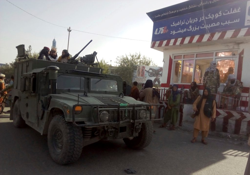 Taliban fighters stand guard at a checkpoint in Kunduz city, northern Afghanistan, on Monday. Photo: AP/Abdullah Sahil