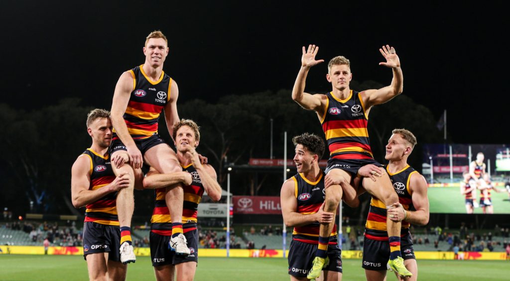 Tom Lynch and David Mackay are chaired off after last weekend's win - their final game for the Crows. Photo:Matt Turner / AAP