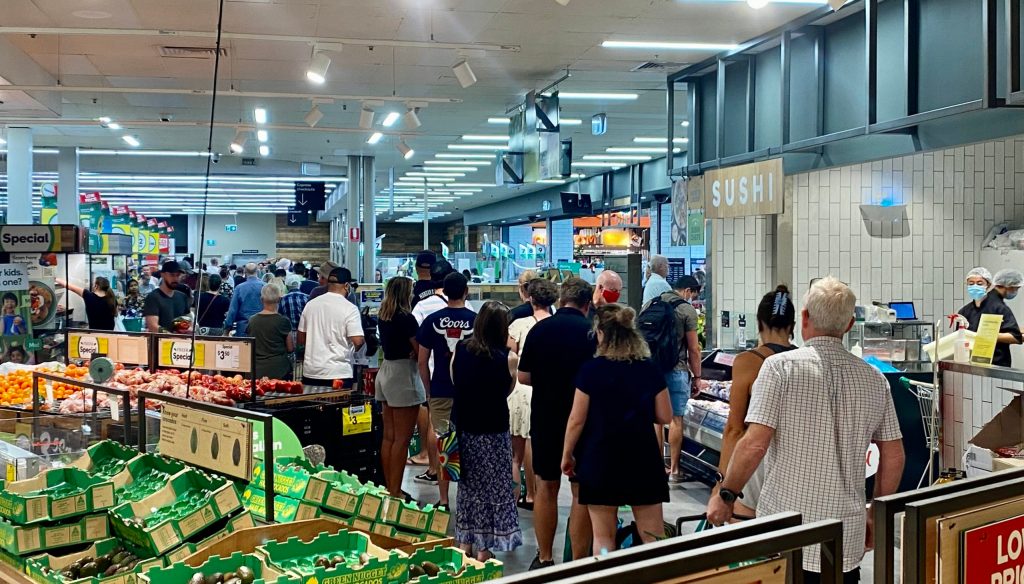 Shoppers queue in a Darwin supermarket after the lockdown announcement. Photo: Tony Lewis/InDaily