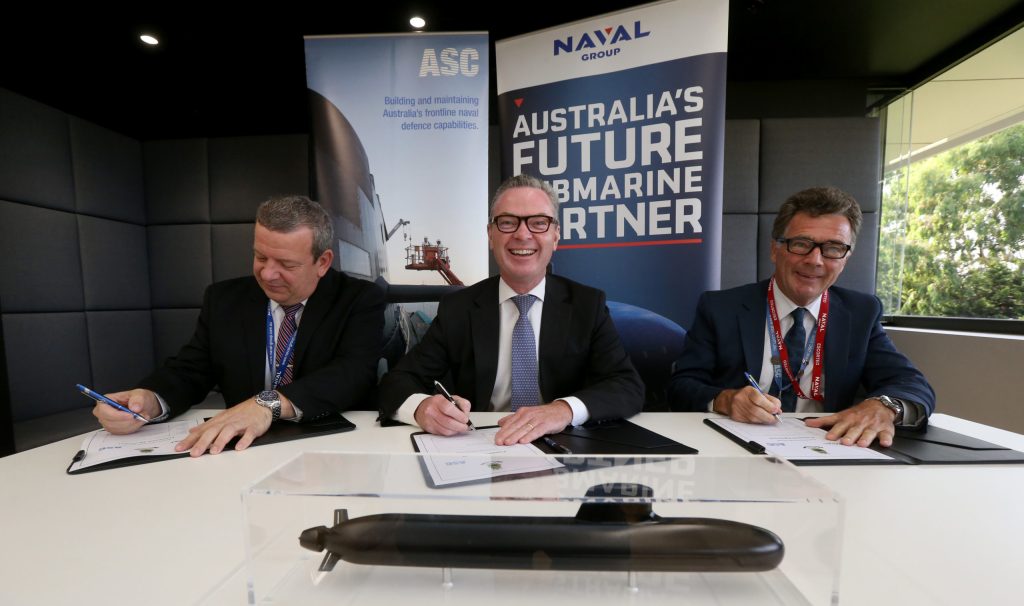 Christopher Pyne signing a working agreement with Naval Group Australia CEO John Davies and ASC CEO Stuart Whiley in 2019. Photo: Kelly Barnes / AAP
