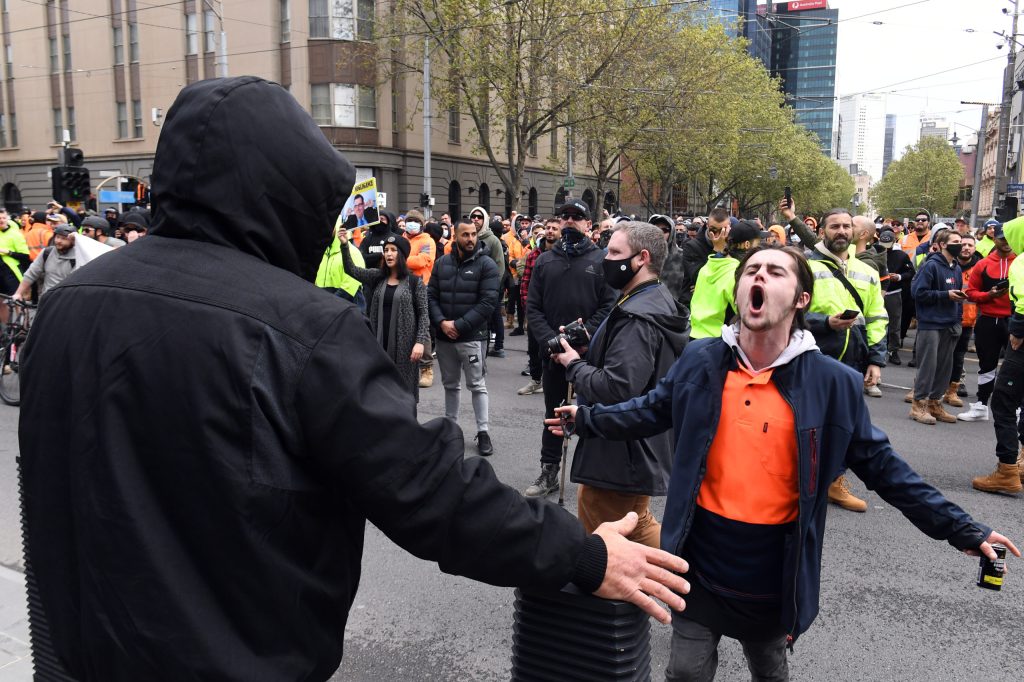 Construction workers are seen at a CFMEU protest outside Victoria’s Parliament House in Melbourne, Tuesday, September 21, 2021. (AAP Image/James Ross).