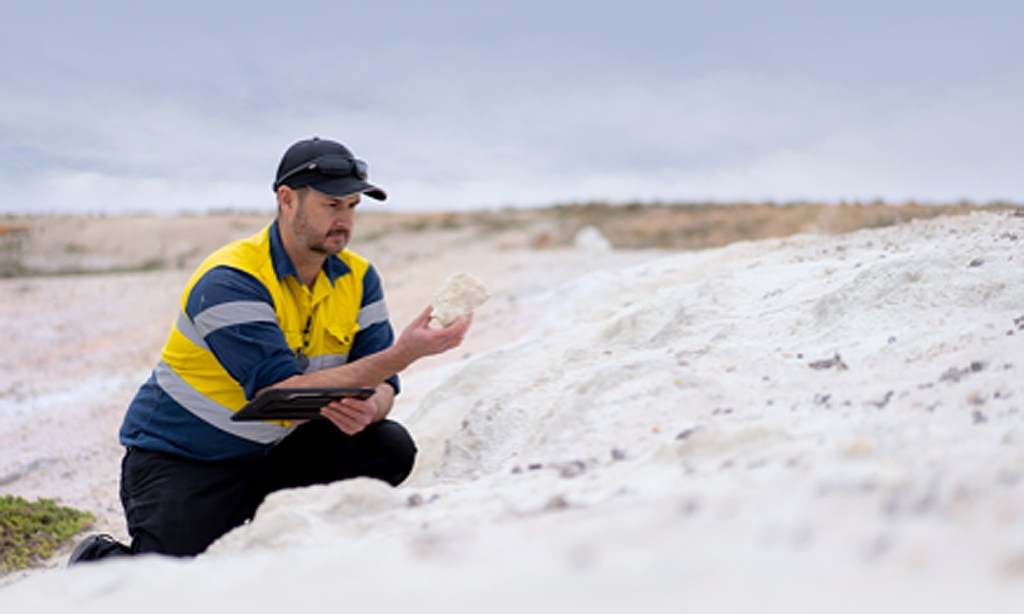 iTech Minerals managing director Michael Schwarz inspects a kaolin sample.