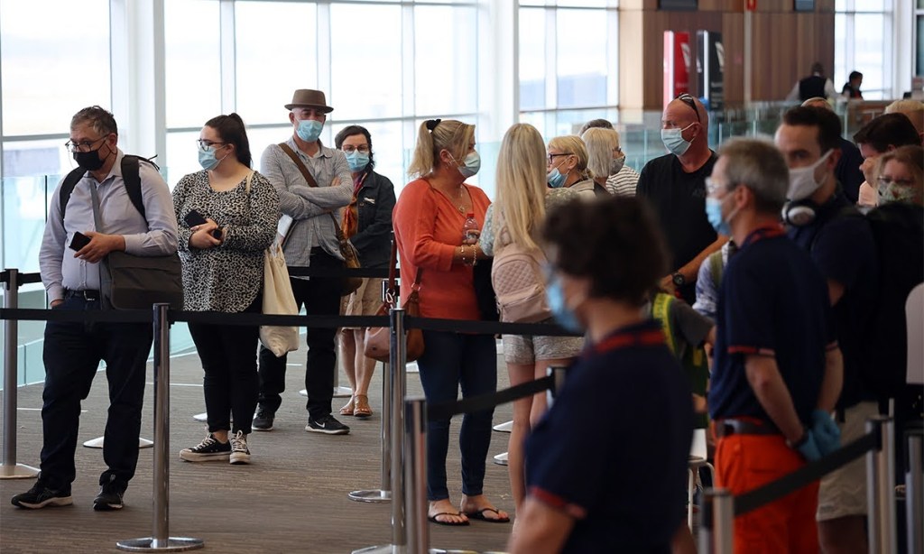 Masked travellers at Adelaide Airport. Photo: Tony Lewis/InDaily