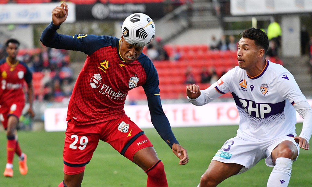 United's Kusini Yengi of United and Perth Glory's Dane Ingham compete at Coopers Stadium in February. Photo: AAP/David Mariuz