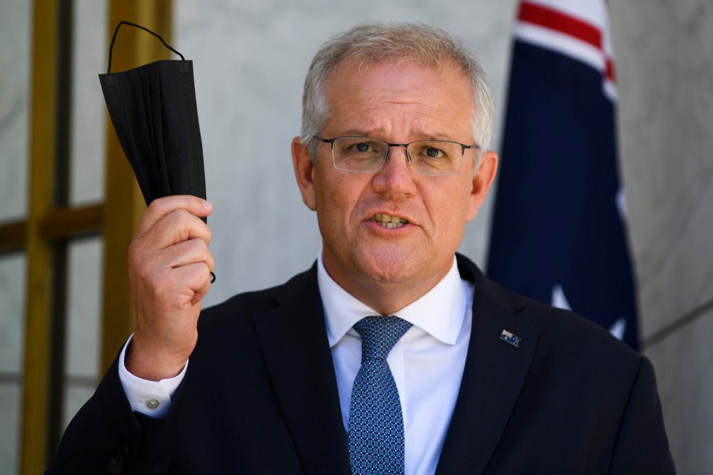 Prime Minister Scott Morrison recommends face masks but won't mandate their use after Wednesday's national cabinet meeting. Photo: AAP/Lukas Coch