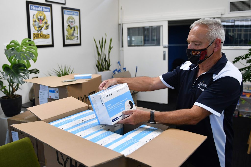 Melbourne school principal Glenn Butler with Rapid Antigen Tests as students prepare to return for face-to-face classes. Photo: AAP/Joel Carrett