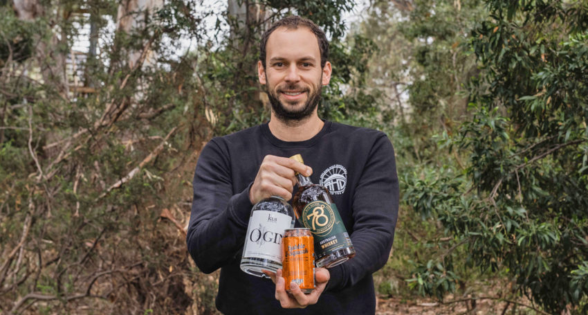 Adelaide Hills Distillery founder Sacha La Forgia with Mighty Craft products including his 78 Degrees Australian Whisky.