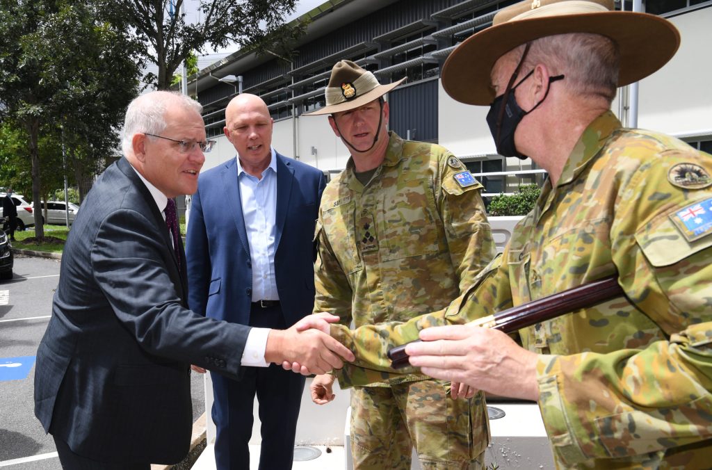 Prime Minister Scott Morrison and Defence Minister Peter Dutton meet army officers during flood recovery operations. Photo: AAP/Darren England