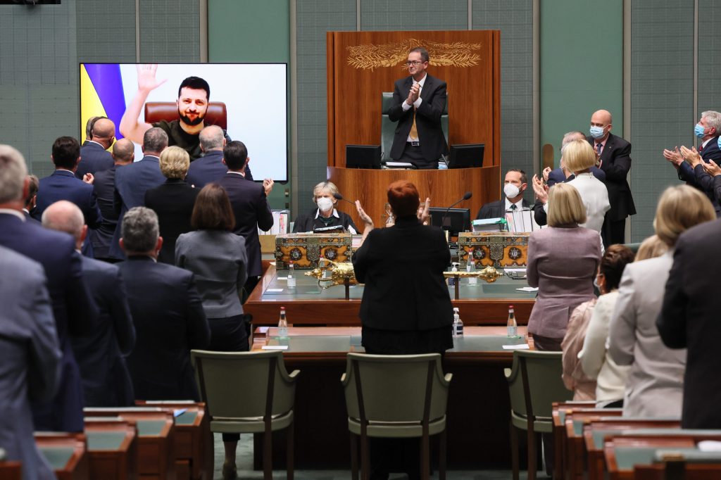 Ukrainian President Volodymyr Zelenskyy receives a standing ovation after addressing the House of Representatives via a video link last night. Photo: Alex Ellinghausen/AAP pool