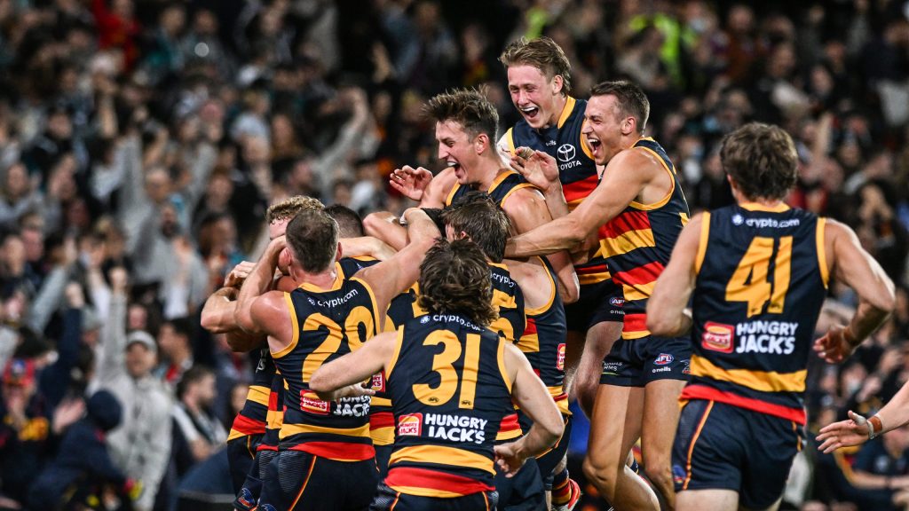 Crows players swamp Jordan Dawson after his clutch goal on Friday night. Photo: Michael Errey / InDaily