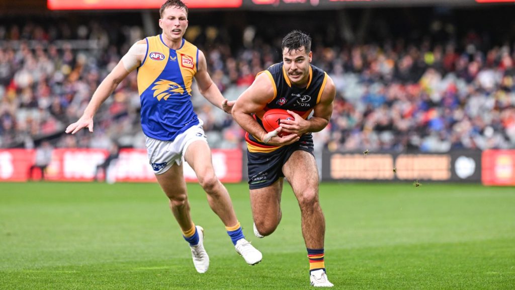 One of the rarest sights in football, Darcy Fogarty evading an opponent. Photo: Michael Errey / InDaily