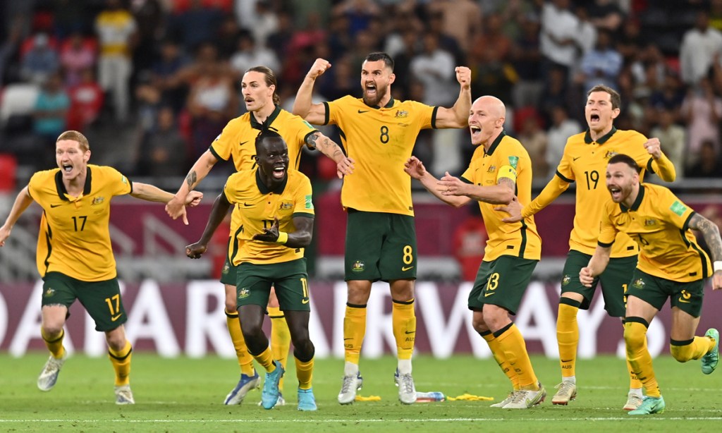 Australian players celebrate a dramatic penalty shootout win over Peru to qualify for the FIFA World Cup 2022.  Photo: Noushad Thekkayil/EPA.