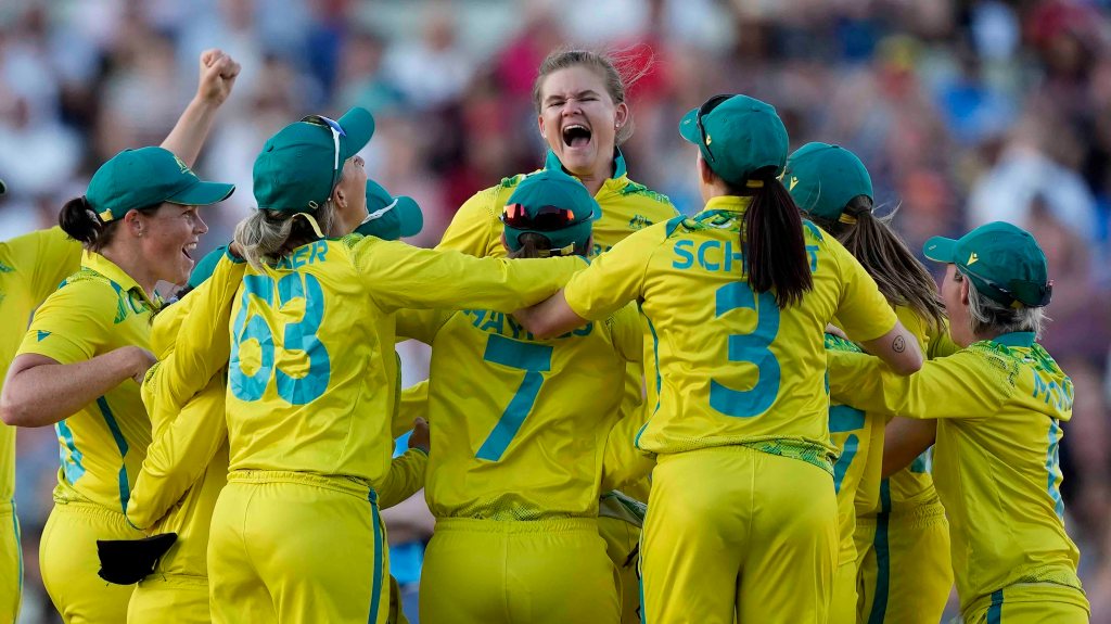 Australia's Jess Jonassen, centre, and teammates celebrate after defeating India at Edgbaston. Photo: AP/Aijaz Rahi