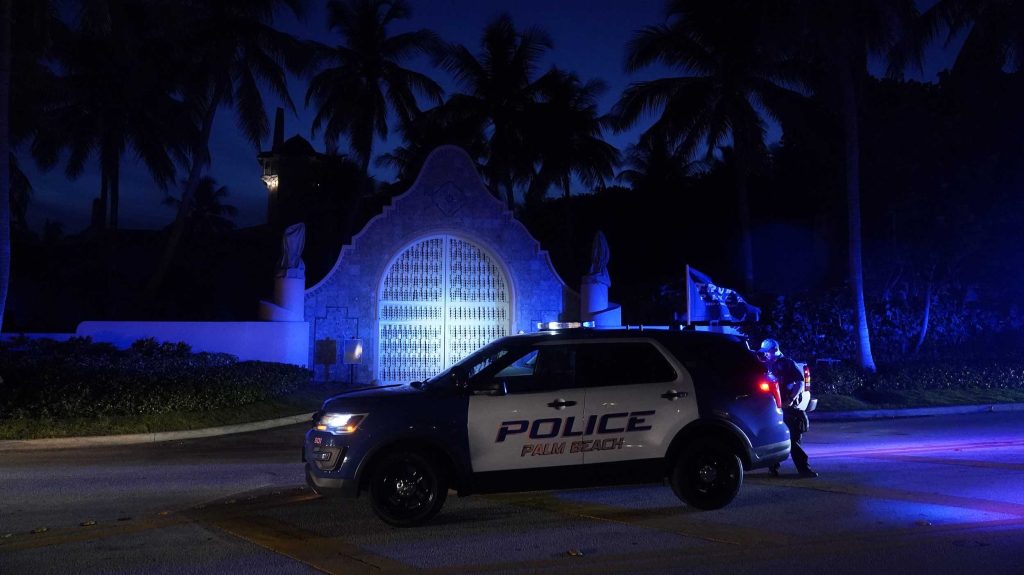 Police stand outside an entrance to former President Donald Trump's Mar-a-Lago estate in Palm Beach. Photo: AP/Wilfredo Lee