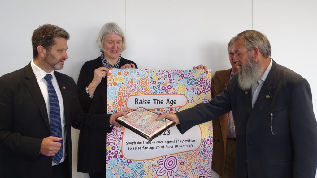 Attorney-General Kyam Maher (left) being presented with a petition to raise the criminal age in South Australia. Photo: Supplied