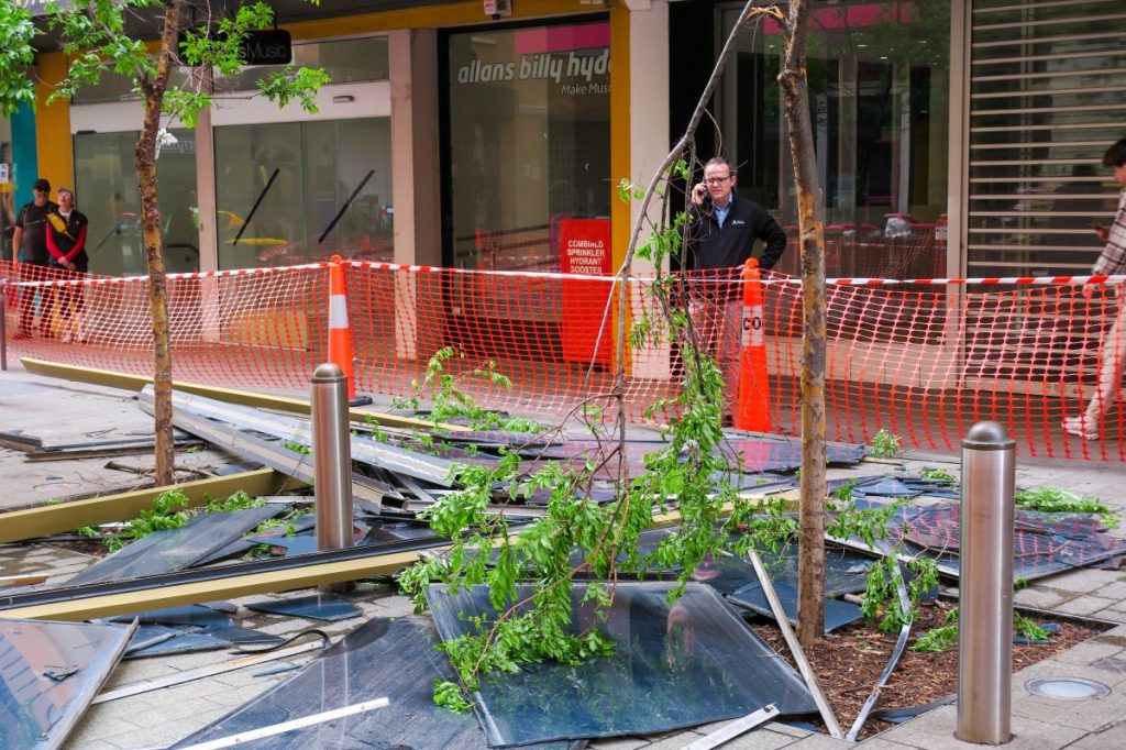 An Adelaide City Council Worker inspects debris following the collapse of a facade on Tuesday night. Picture Jason Katsaras
