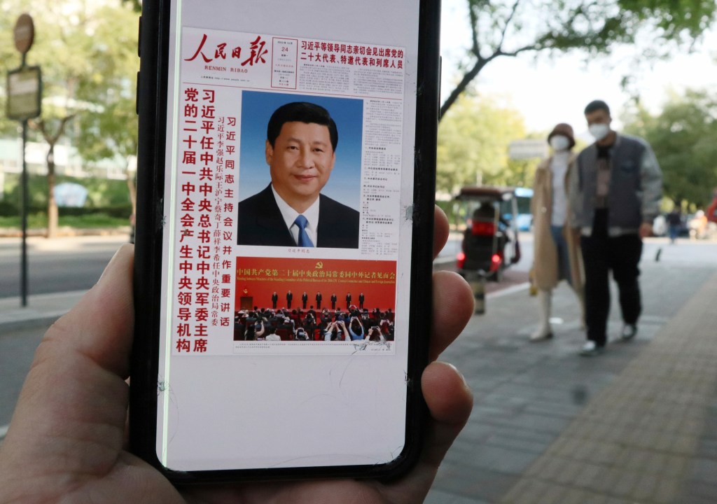 The People's Daily announces that China's President Xi Jinping has secured a third five-year term as general secretary in Beijing on Oct. 24. Photo: The Yomiuri Shimbun via AP Images 