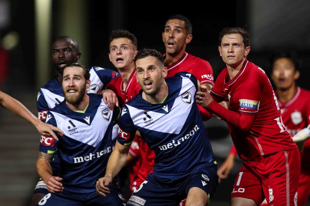 Victory's Jason Geria (rear left) and  United's Craig Goodwin (right) among a slew of others during the Adelaide-Melbourne clash earlier this year. Photo: AAP/Matt Turner