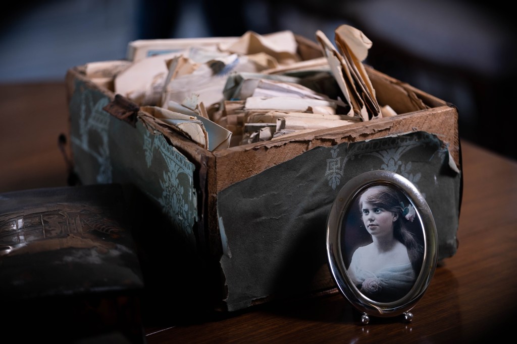 A photograph of Vera in front of some of the letters she received from soldiers. Photo courtesy the ABC