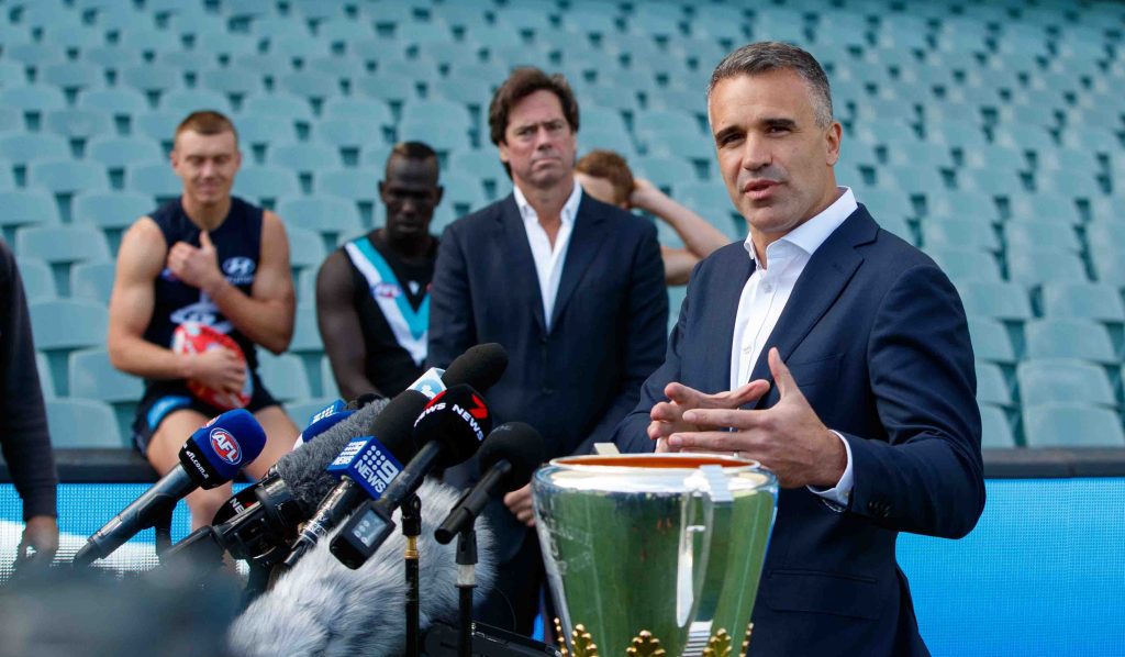 South Australian Premier Peter Malinauskas launching the AFL's Gather Round - an event which will almost certainly increase COVID infections. Photo: AAP/Matt Turner