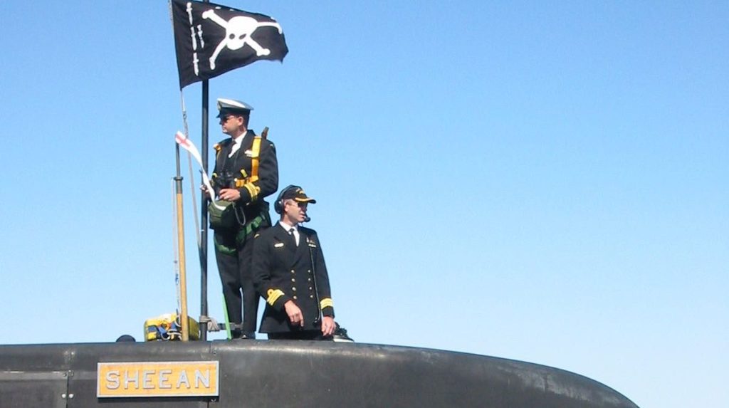 Former HMAS Sheean submarine commander Andy Keough (right). The skull and crossbones flag is flown on return from operations. Photo: supplied