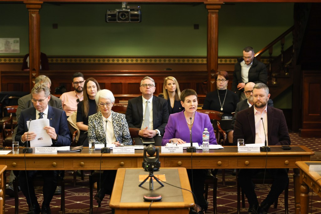 (L-R) University of Adelaide vice-chancellor Peter Høj and chancellor Catherine Branson with UniSA chancellor Pauline Carr and vice-chancellor David Lloyd at the university merger committee inquiry on Tuesday. Photo: Tony Lewis/Indaily