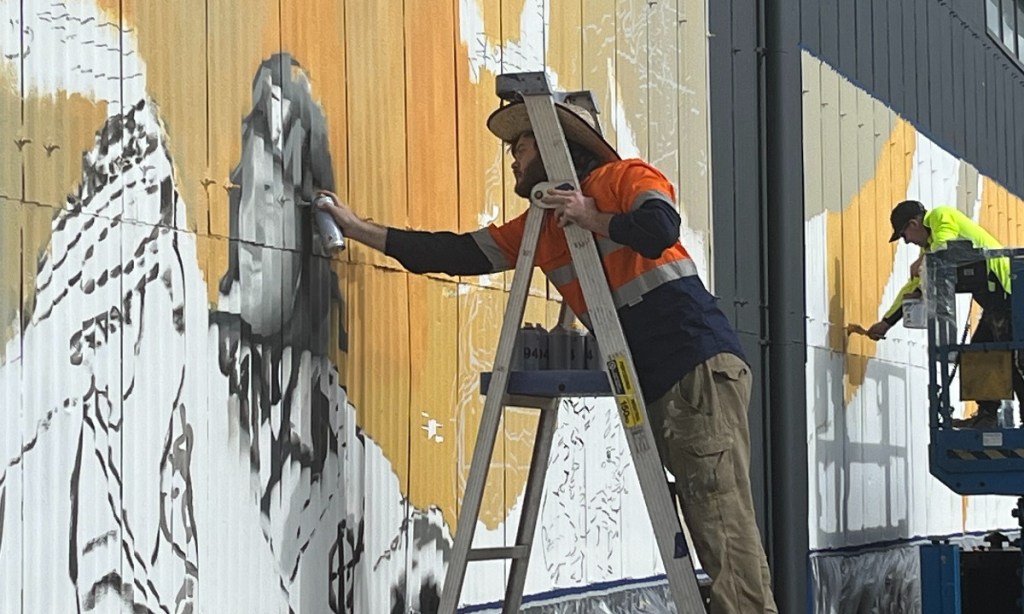 Sam Brooks (foreground) and Mark Harding will complete the Port Pirie aerodrome  mural by the end of August.