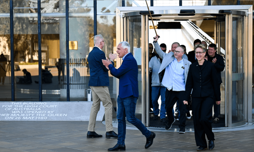 TWU leader Michael Kaine and ACTU Secretary Sally McManus with sacked Qantas workers celebrating their High Court win. Photo: AAP/Lukas Koch