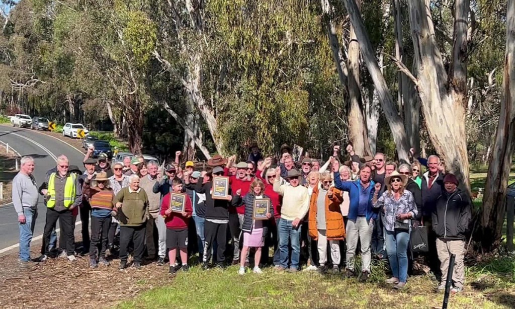 River Road protesters at a photo-op. The Premier wouldn't come to them, so one of their group gatecrashed his media opportunity.
