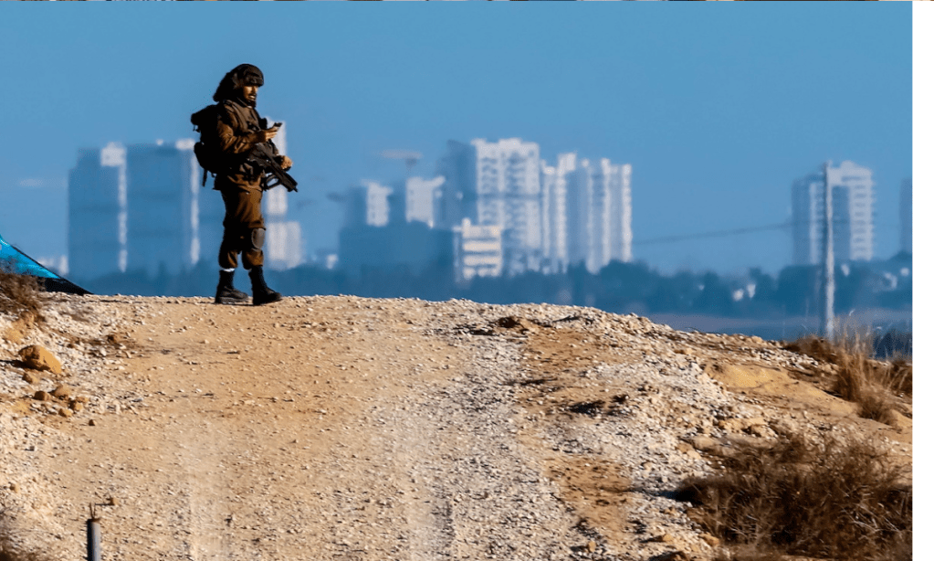 An Israeli soldier patrols on a road near the Gaza strip. Photo: Hannibal Hanschke/EPA