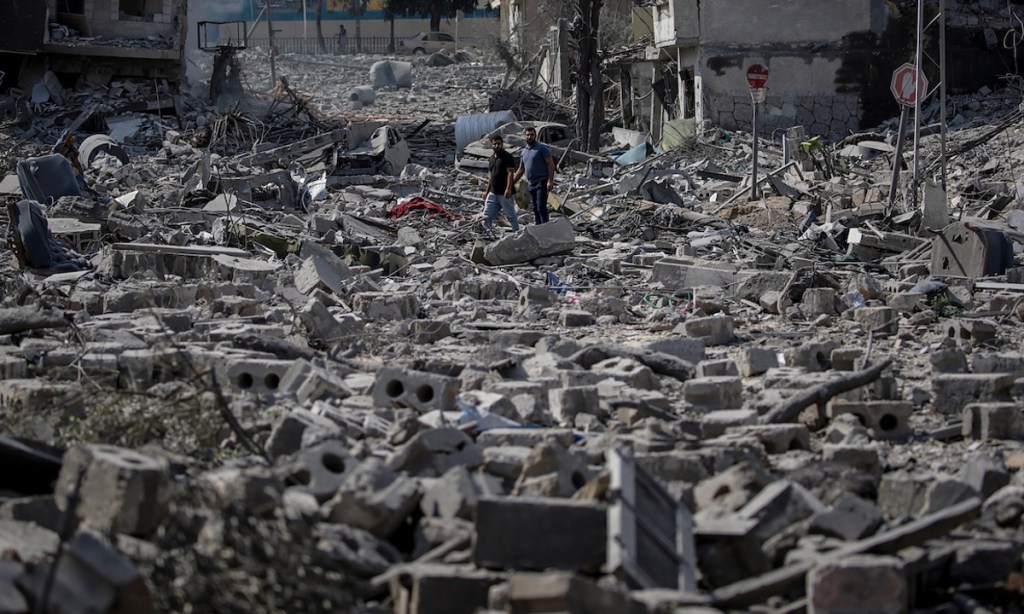 Palestinians stand in the destroyed Al-Ramal neighborhood following an Israeli air strike in Gaza City, 10 October 2023. Photo: AAP.