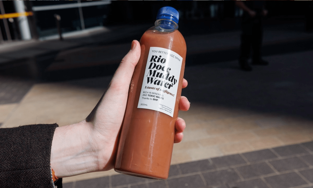A bottle of contaminated water carried by protesters at today's BHP AGM. Photo: Tony Lewis/InDaily