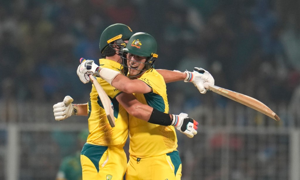 Australia's captain Pat Cummins and Mitchell Starc celebrate their win against South Africa. Photo: AP/Aijaz Rahi